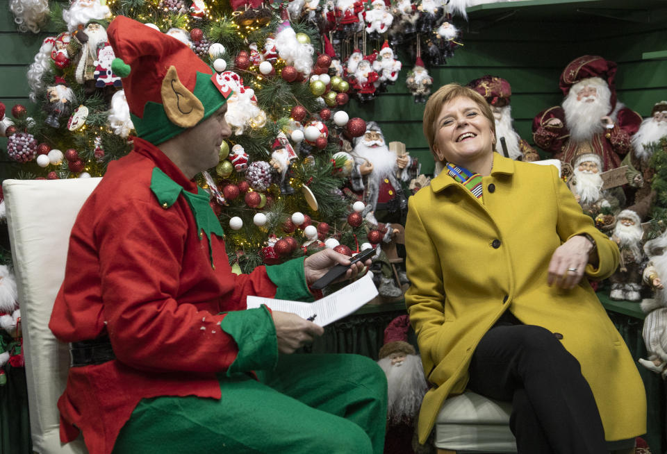 SNP leader Nicola Sturgeon is interviewed by a journalist dressed as a Christmas elf in the Nutcracker Christmas Village shop during a visit to Crieff Visitors Centre, Crieff, on the General Election campaign trail.