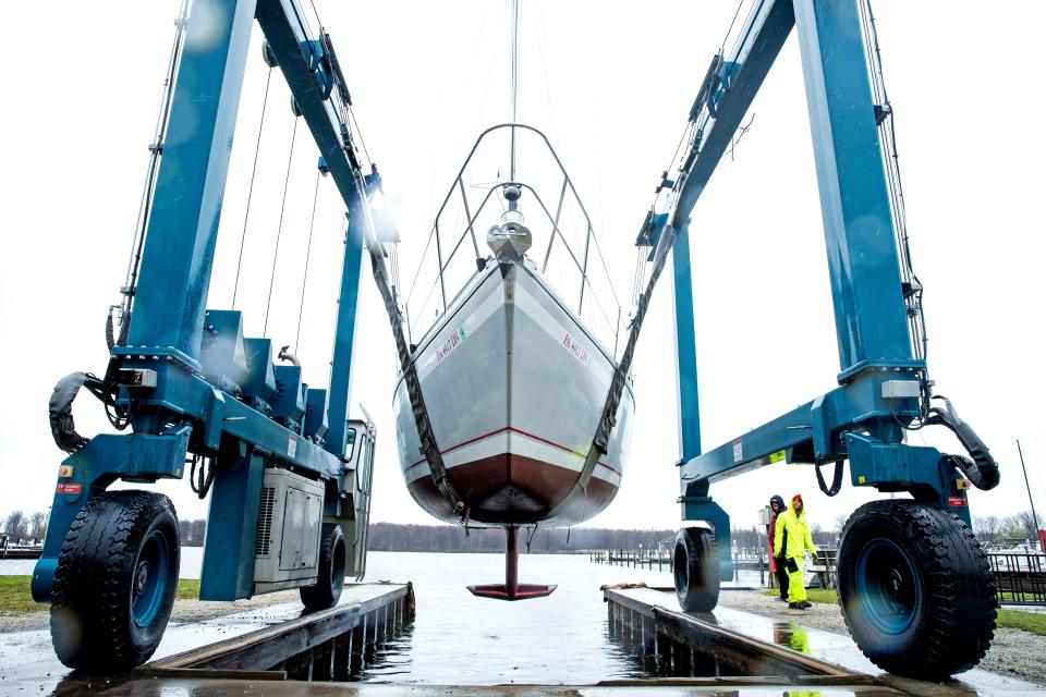 A sailboat called Yemayá is lowered into the water at Presque Isle Marina, in the rain on May 6, 2022. Yemayá is named after an African and Brazilian goddess of the seas. The 30-foot sailboat, according to her owner, Dave Dunn, originally sailed in Lake Ontario. An improvement project started last fall at the marina is nearing completion.