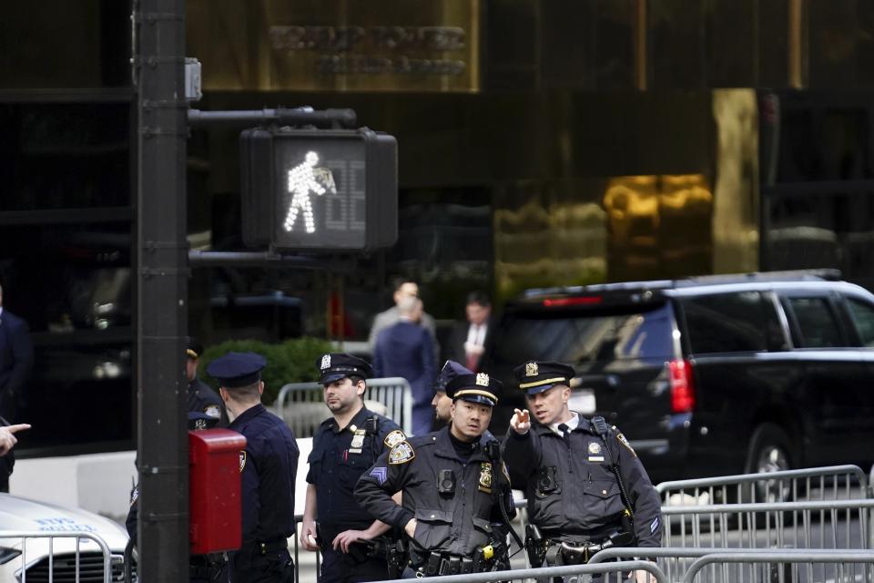 Members of the NYPD direct the closing of sideways at 56th Street at 5th Avenue, near Trump Tower, Monday, April 3, 2023 in New York. Former President Donald Trump is expected to travel to New York to face charges related to hush money payments. Trump is facing multiple charges of falsifying business records, including at least one felony offense, in the indictment handed up by a Manhattan grand jury. (AP Photo/Bryan Woolston)