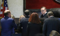 Judge Thad Balkman speaks with attorneys during the opioid trial Monday, June 24, 2019 in Norman, Okla. (AP Photo/Sue Ogrocki, Pool)