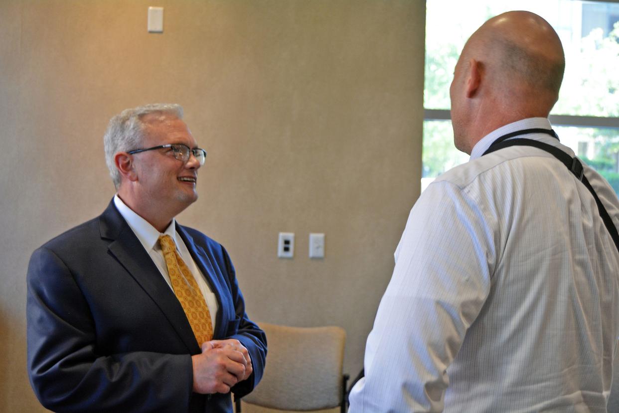 Brian Schaeffer, an assistant fire chief for the Spokane, Washington, Fire Department and finalist for Columbia's fire chief, is surprised by his college roommate June 6 during a meet-and-greet event at Columbia City Hall