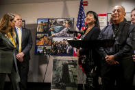 Evelyn and Carlos Baltierra, right, parents of Pvt. 1st Class Bryan Baltierra, show pictures of their son at a press conference on Thursday, July 29, 2021, in Oceanside, Calif. The families of eight Marines and one sailor who died when their amphibious assault vehicle sank off the Southern California coast in the summer of 2020 plan to sue the manufacturer of the vehicle that resembles an armored seafaring tank, their lawyers announced Thursday. (Sam Hodgson/The San Diego Union-Tribune via AP)