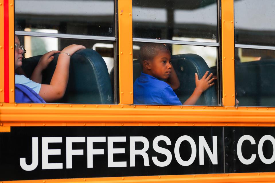 A student looks out of a JCPS bus that's stopped outside Shaffner Elementary in Shively Wednesday morning for the first day of classes. Aug. 9, 2023. 