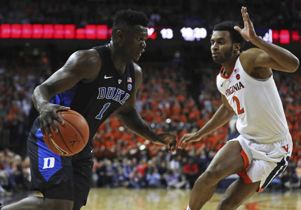 Duke forward Zion Williamson (1) drives past Virginia's guard Braxton Key during the first half of an NCAA college basketball game Saturday, Feb. 9, 2018, in Charlottesville, Va. (AP Photo/Zack Wajsgras)