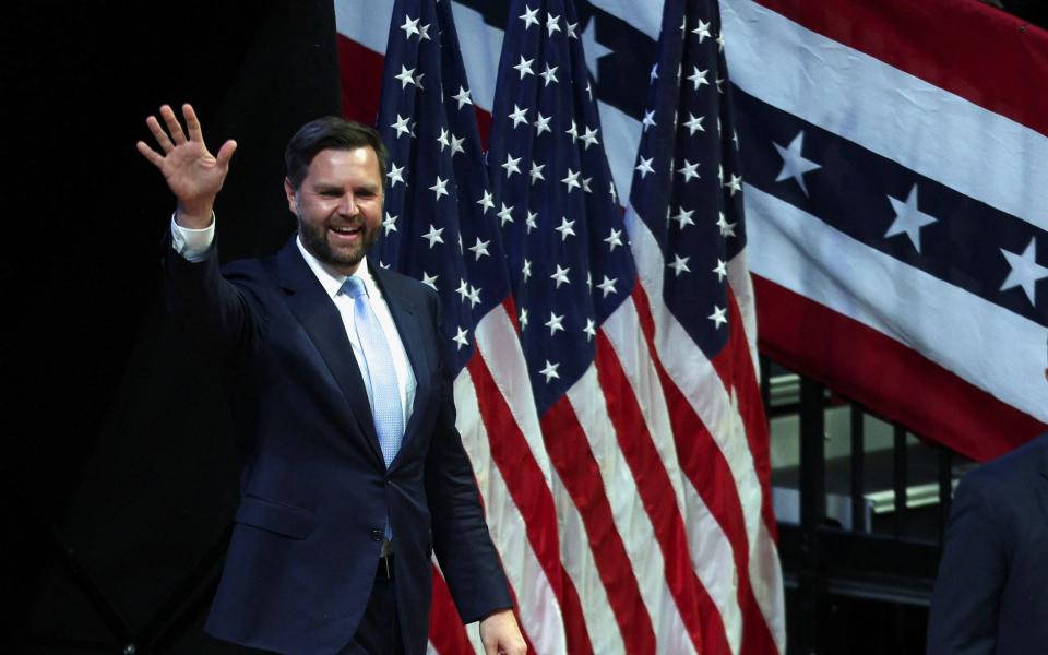 JD Vance waves during his first rally as Republican vice-presidential nominee