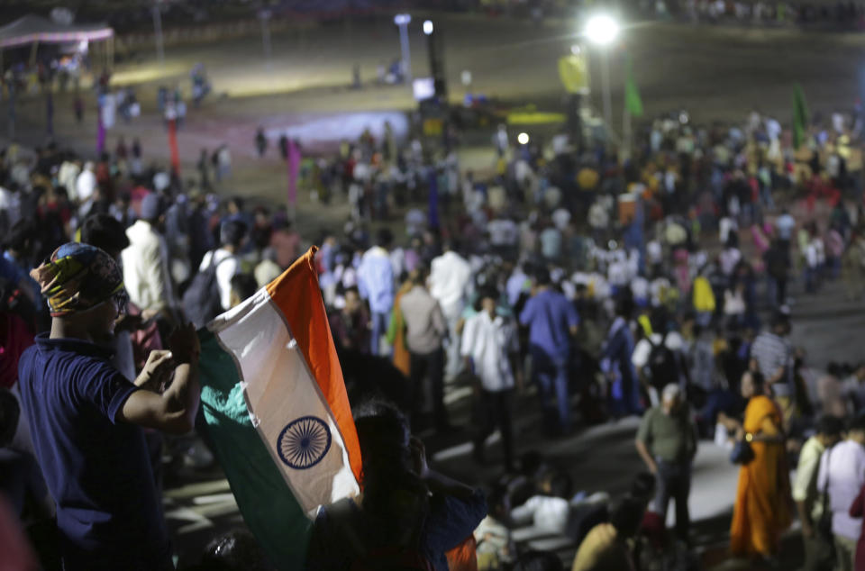 An Indian spectator folds Indian national flag as others leave after the Chandrayaan-2 mission was aborted at Sriharikota, in southern India, Monday, July 15, 2019. India has called off the launch of a moon mission to explore the lunar south pole. The Chandrayaan-2 mission was aborted less than an hour before takeoff on Monday. An Indian Space Research Organization spokesman says a "technical snag" was observed in the 640-ton launch-vehicle system. (AP Photo/Manish Swarup)