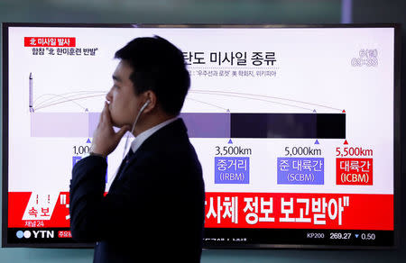 A man walks past a television broadcasting a news report on North Korea firing ballistic missiles, at a railway station in Seoul, South Korea, March 6, 2017. REUTERS/Kim Hong-Ji