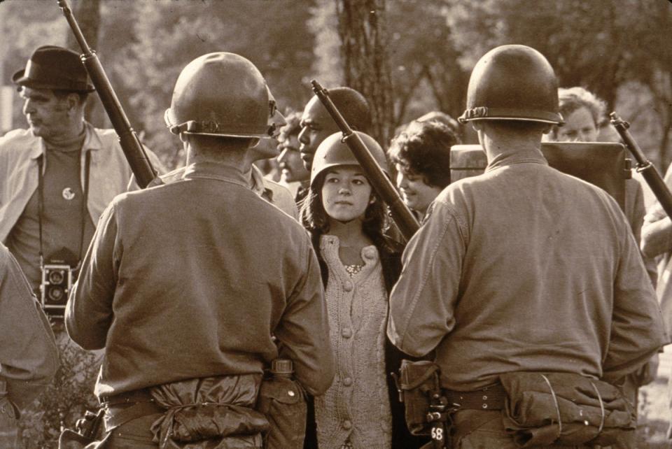 A young female protester wearing faces down helmeted and armed police officers at an anti-Vietnam War demonstration outside the 1968 Democratic National Convention in Chicago, Illinois, during August 1968 (Getty Images)