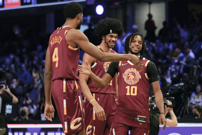 Cleveland Cavaliers' Darius Garland (10) celebrates with teammates Evan Mobley (4) and Jarrett Allen after winning the team shooting part during the skills challenge competition, part of NBA All-Star basketball game weekend, Saturday, Feb. 19, 2022, in Cleveland. (AP Photo/Charles Krupa)