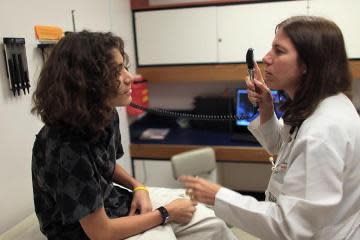 A Miami doctor examines a patient