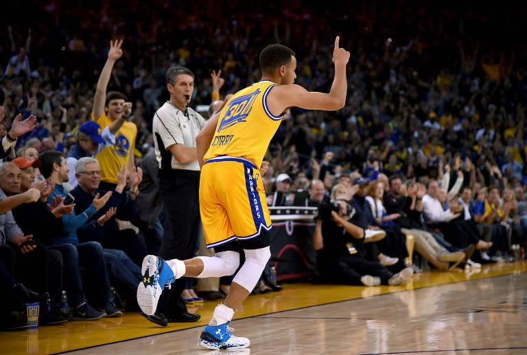 Stephen Curry of the Golden State Warriors reacts after hitting a three-point shot on November 24, 2015 in Oakland, California