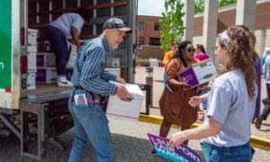 Petitioners with Missourians for Healthy Families and Fair Wages unload dozens of boxes of signatures to deliver to the Secretary of State Wednesday afternoon.