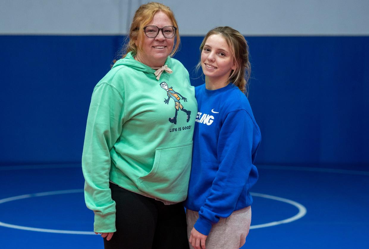 Jodie Horger, left, with her daughter Julia Horger, a sophomore wrestler at Conwell-Egan, pose for a portrait at Misfits Wrestling, a gym Jodie Horger founded for girl wrestlers,