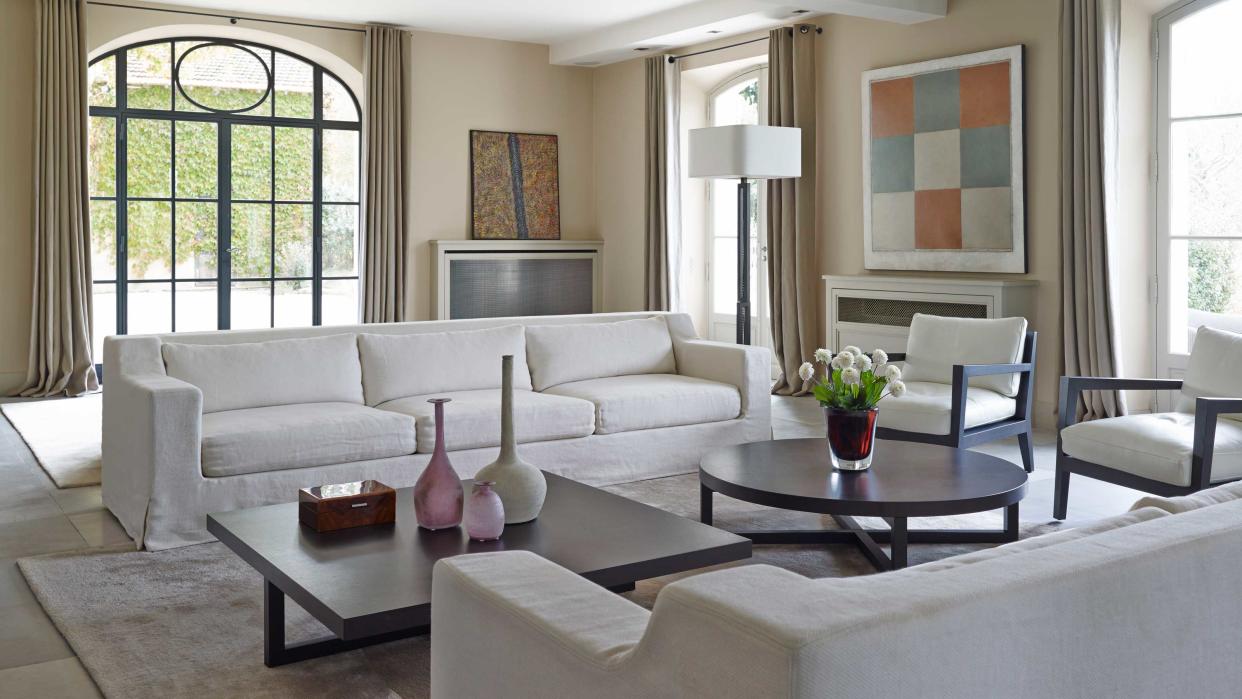  living room with white couches and chairs 