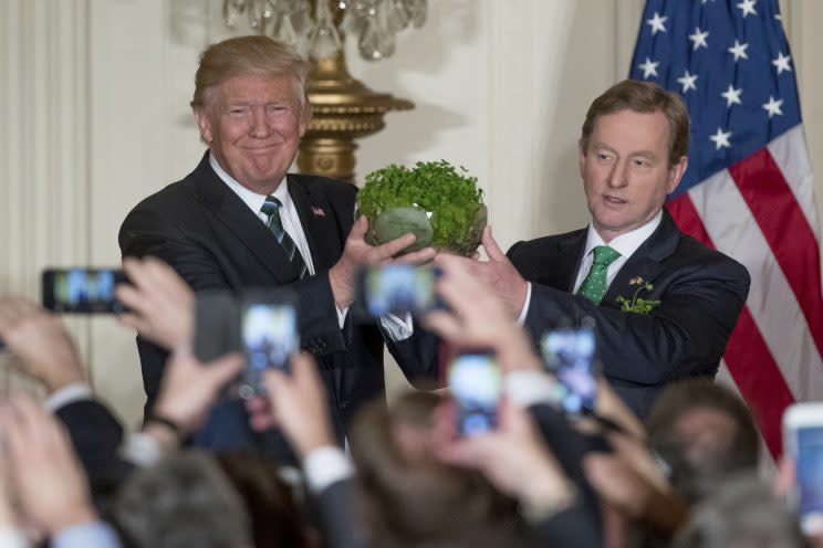 President Trump and Irish Prime Minister Enda Kenny, right, hold up a bowl of Irish shamrocks during a St. Patrick’s Day reception in the East Room of the White House on March 16, 2017. (Andrew Harnik/AP)