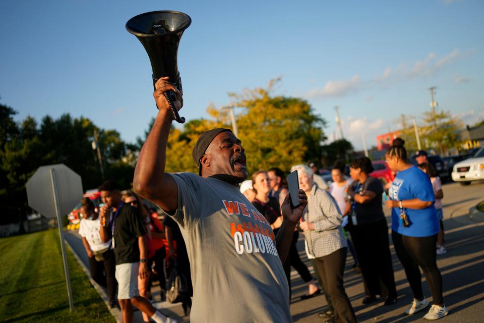 Linden community advocate Derrick Russell, a former gang leader of the Short North Posse and convicted drug dealer who has been out of prison for 15 years, leads a recent walk throughout Linden aimed at ending gun violence in Columbus. The group passed out informational packets from local organizations and shouted messages of encouragement.