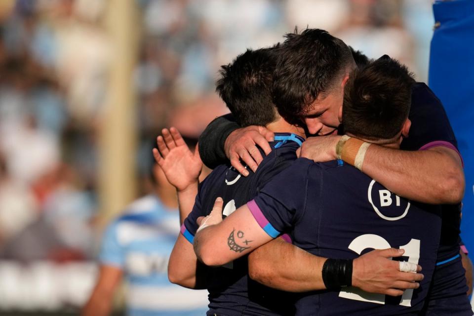 Sam Johnson, left, celebrates with team-mates after scoring Scotland’s fourth try in their victory over Argentina (Natacha Pisarenko/AP) (AP)