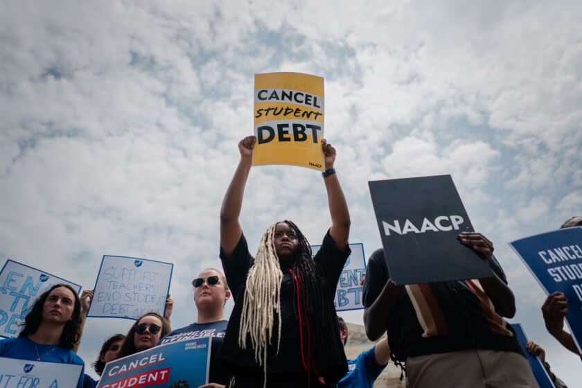 WASHINGTON, DC - JUNE 30: D'Aungilique Jackson, of Fresno, CA holds a "Cancel Student Debt" sign outside of the Supreme Court of the United States after the nation's high court stuck down President Biden's student debt relief program on Friday, June 30, 2023 in Washington, DC. In a 6-3 decision the Supreme Court stuck down the Biden administration's student debt forgiveness program in Biden v. Nebraska. (Kent Nishimura / Los Angeles Times)