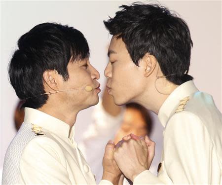 South Korean film director Kim Jho Gwang-soo (L) kisses his partner Kim Seung-hwan during their wedding ceremony in central Seoul September 7, 2013. Kim Jho Gwang-soo married his long-term partner on Saturday in this conservative Asian country where homosexuality is still taboo and gays have been subjected to hate crimes. REUTERS/Lee Jae-Won