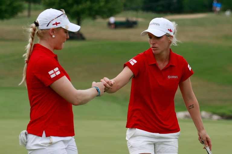 Charley Hull (L) and Melissa Reid of England celebrate after winning a hole during the four-ball session of the 2016 UL International Crown, at the Merit Club in Chicago, Illinois, on July 23