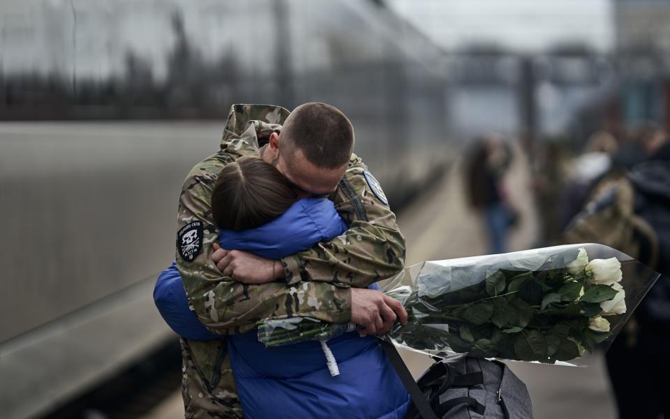 A soldier greets his partner at the last station before the Donbas frontline on the eve of Valentine's Day