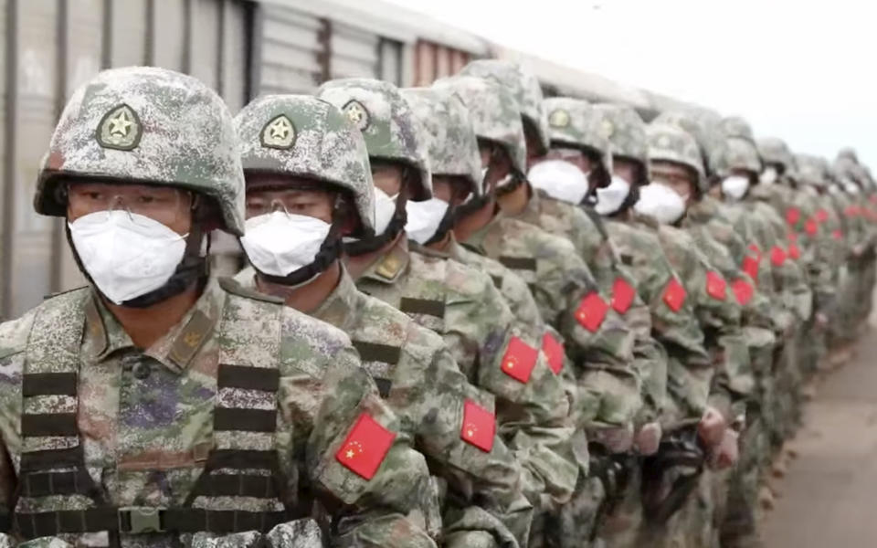 In this handout photo taken from video released by Russian Defense Ministry Press Service on Monday, Aug. 29, 2022, Chinese soldiers arrive to the Grodekovo railway station to participate in war games drills, in Grodekovo, Primorsky Krai, Russia. Russia said Monday it will launch sweeping war games drills in the country's east that will involve forces from China — a show of increasingly close military ties between Moscow and Beijing amid tensions with the West over the Kremlin's action in Ukraine. (Russian Defense Ministry Press Service via AP)