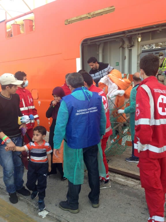 Women and children disembark from the Siem Pilot ship on October 24, 2016 in Palermo after rescue operations of migrants off the coast of Libya three days earlier