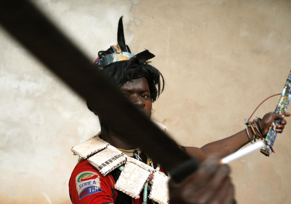 A member of Anti-balaka, a Christian militia, gestures with his machetes in village of Zawa