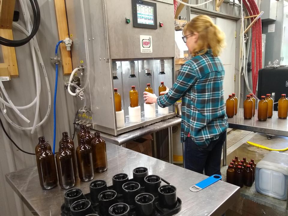Kerry Croghan bottles the Rustic Helles on a semi-automated four-head bottling station. The machine and a skilled operator can fill about 100 bottles per hour.