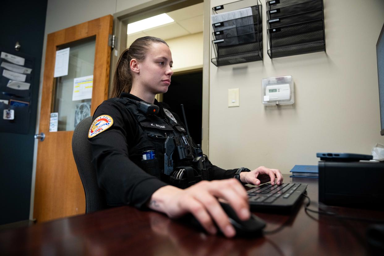 Officer Kelsie Stone works on a report after her shift Monday, March 25, 2024, at the Urbandale Police Department.