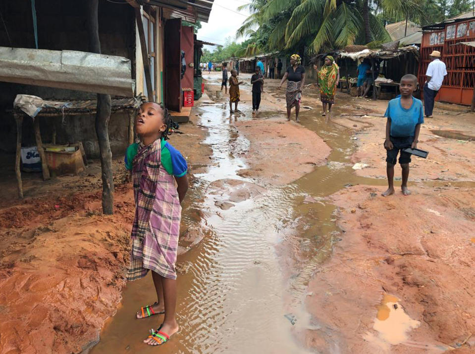 A child drinks water from a gutter during floods due to heavy rains in Pemba, Mozambique, Sunday, April 28, 2019. Serious flooding began on Sunday in parts of northern Mozambique that were hit by Cyclone Kenneth three days ago, with waters waist-high in areas, after the government urged many people to immediately seek higher ground. Hundreds of thousands of people were at risk. (AP Photo/Tsvangirayi Mukwazhi)