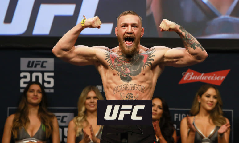 Conor McGregor flexing his biceps.