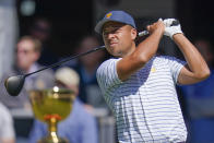 Xander Schauffele hits from the first tee during their fourball match at the Presidents Cup golf tournament at the Quail Hollow Club, Friday, Sept. 23, 2022, in Charlotte, N.C. (AP Photo/Julio Cortez)
