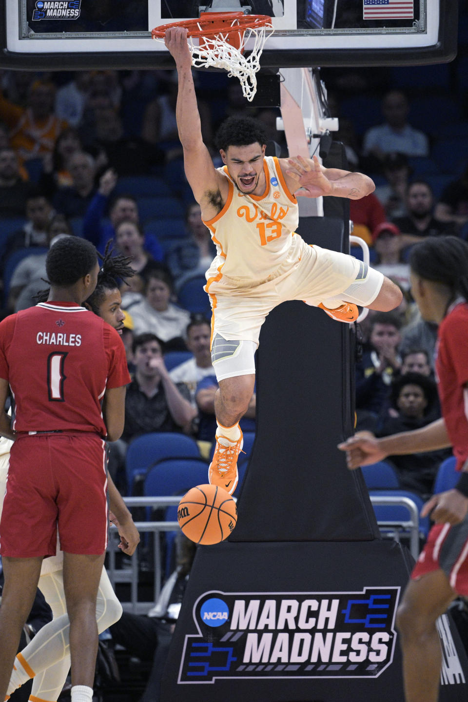 Tennessee forward Olivier Nkamhoua (13) dunks as Louisiana forward Joe Charles (1) watches during the second half of a first-round college basketball game in the men's NCAA Tournament, Thursday, March 16, 2023, in Orlando, Fla. (AP Photo/Phelan M. Ebenhack)