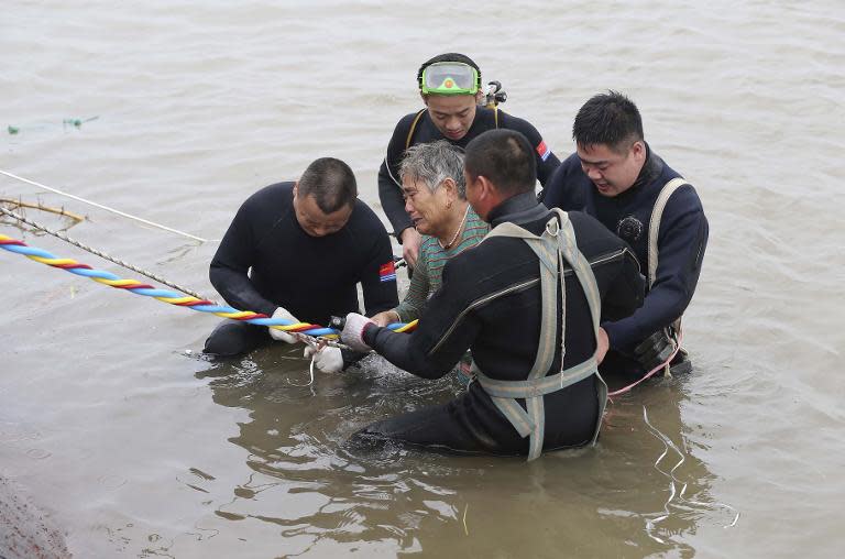 Chinese divers rescue an elderly passenger from the Dongfangzhixing ferry which sank in the Yangtze river, Hubei province, on June 2, 2015
