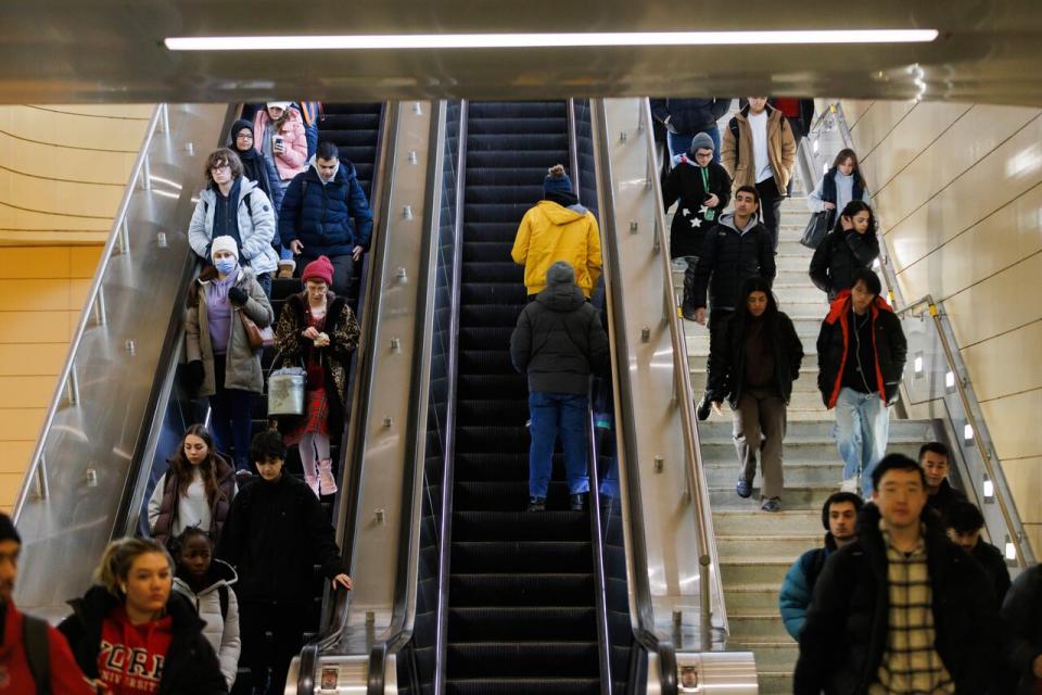 Commuters ride an escalator and walk the stairs at a TTC subway station in Toronto on Monday, Feb. 5, 2024.   THE CANADIAN PRESS/Cole Burston