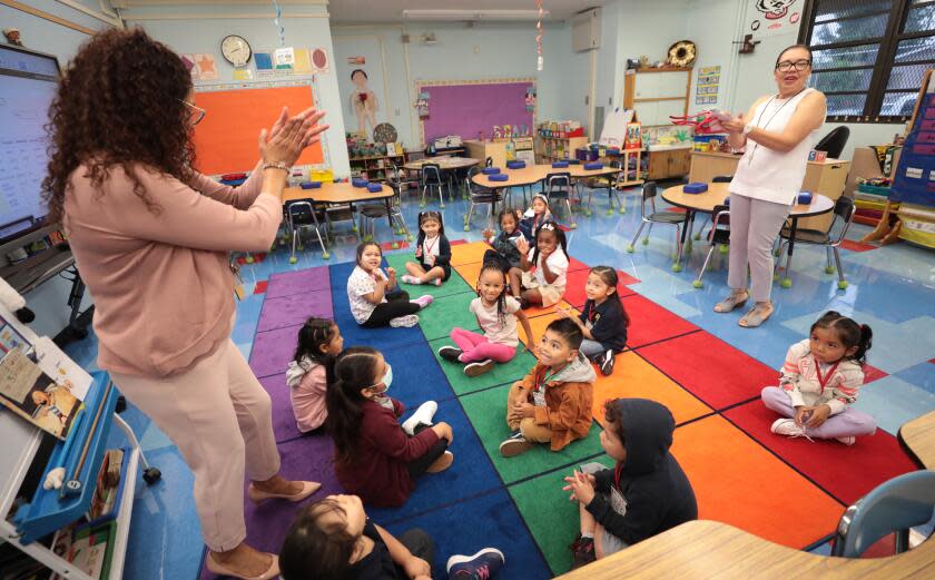 LOS ANGELES CA AUGUST 14, 2023 - TK students clap with teacher Matilde Lopez, right and coach Claudia Mesa, left, on the first day of school at Weemes Elementary School in Los Angeles on Monday, Aug. 14, 2023. (Al Seib / For The Times)