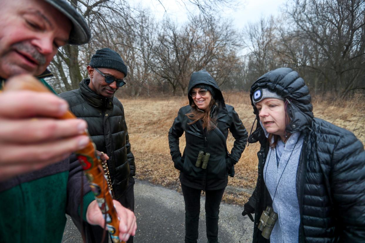 From left to right, Grant Lubin and George Mlay show off their hiking sticks to Amy Riesing and Lisa Weber after a family hike at Havenwoods State Forest in March.