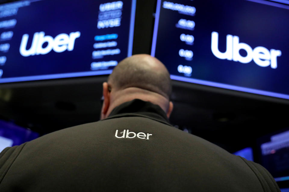 A trader wears the Uber logo on his back on the floor of the New York Stock Exchange (NYSE) during the Uber Technologies Inc. IPO in New York, U.S., May 10, 2019. REUTERS/Andrew Kelly