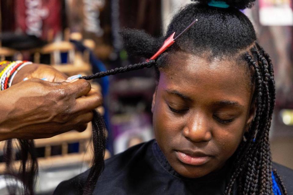 Sonia Ekemon styles box braids for her daughter, Catherine, 12, at African Braiding Salon by Sonia Ekemon, her business located at Phenix Salon Suites in Meridian.