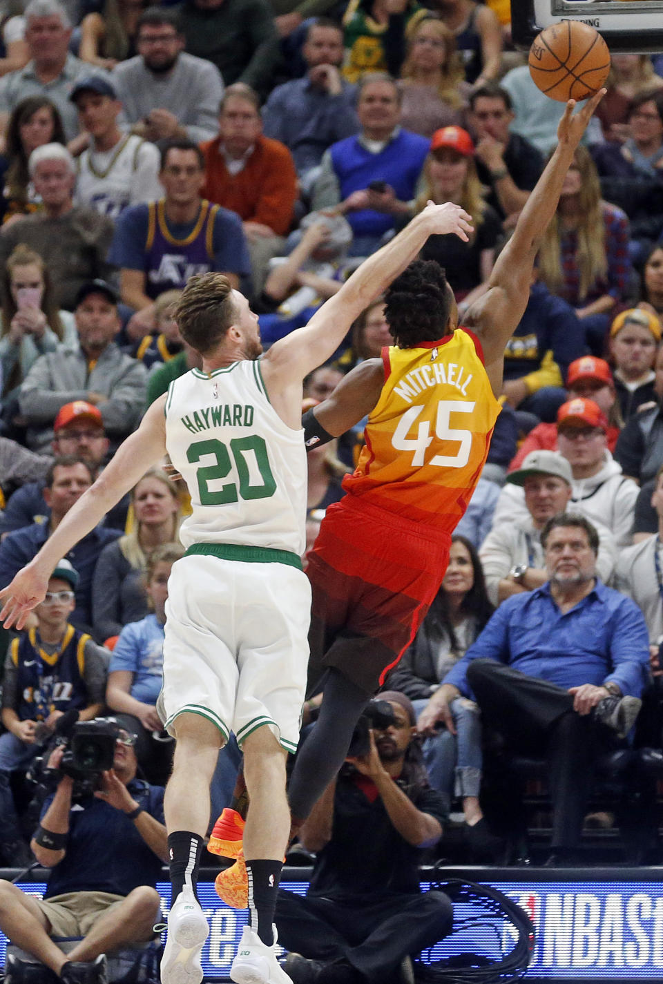 Utah Jazz guard Donovan Mitchell (45) lays the ball up as Boston Celtics forward Gordon Hayward (20) defends during the second half during an NBA basketball game Friday Nov. 9, 2018, in Salt Lake City. (AP Photo/Rick Bowmer)