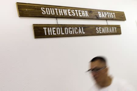 An offender walks past the Southwestern Baptist Theological Seminary sign hanging on a wall inside the Darrington Unit of the Texas Department of Criminal Justice men's prison in Rosharon, Texas August 12, 2014. REUTERS/Adrees Latif