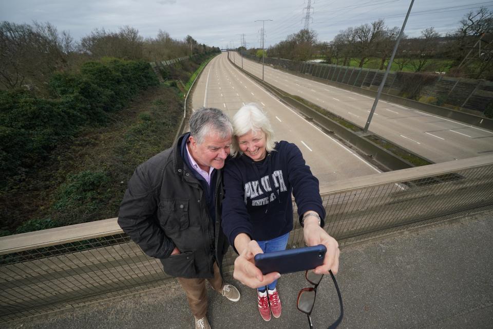 Fiona and Patrick Potter, residents of West Byfleet take a selfie on the Parvis Road bridge in Byfleet (Yui Mok/PA Wire)