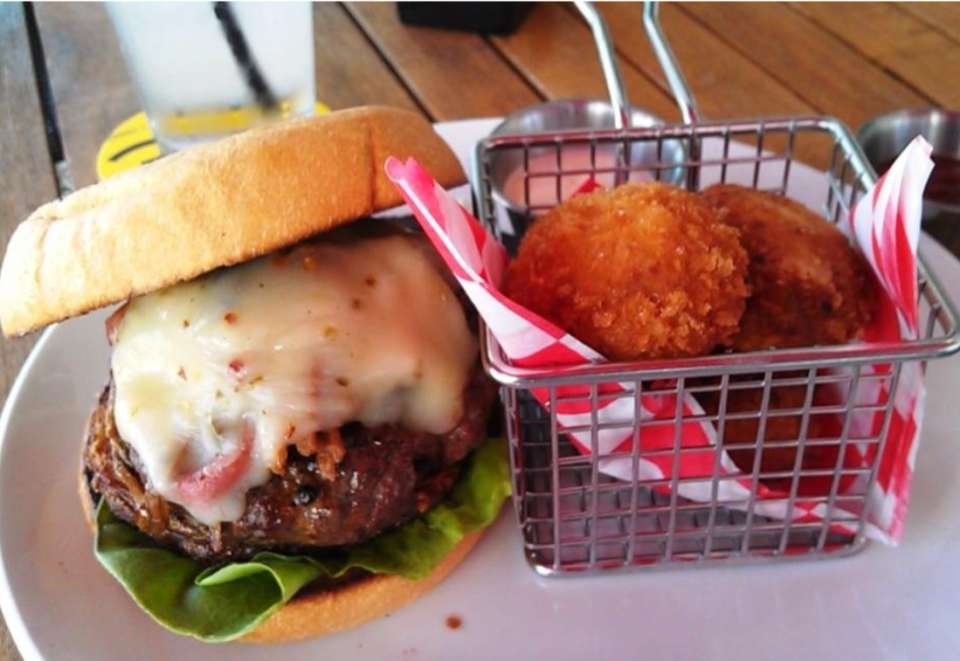 The signature burger at Made Restaurant (1990 Main St., Sarasota) with a side of cheesy tots.