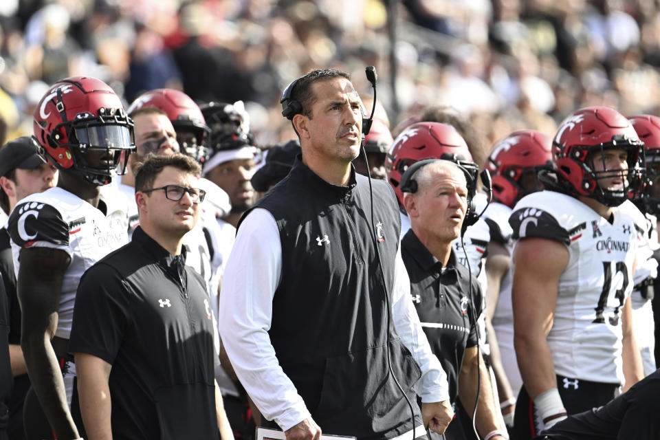 Cincinnati head coach Luke Fickell, center, watches on the sideline during the first half of an NCAA college football game against Central Florida, Saturday, Oct. 29, 2022, in Orlando, Fla. (AP Photo/Phelan M. Ebenhack)