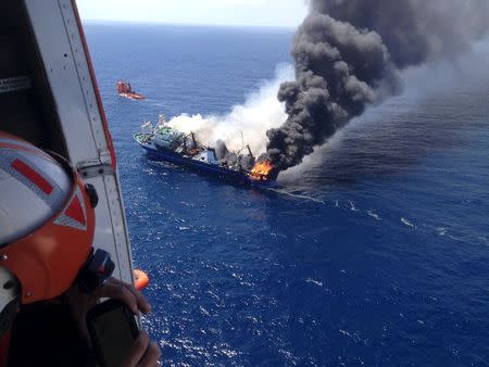 The Oleg Naydenov, a Russian fishing trawler full of fuel, which caught fire over the weekend in Gran Canaria's port of Las Palmas, can be seen in this handout picture taken April 12, 2015. REUTERS/Salvamento Maritimo/Handout via Reuters