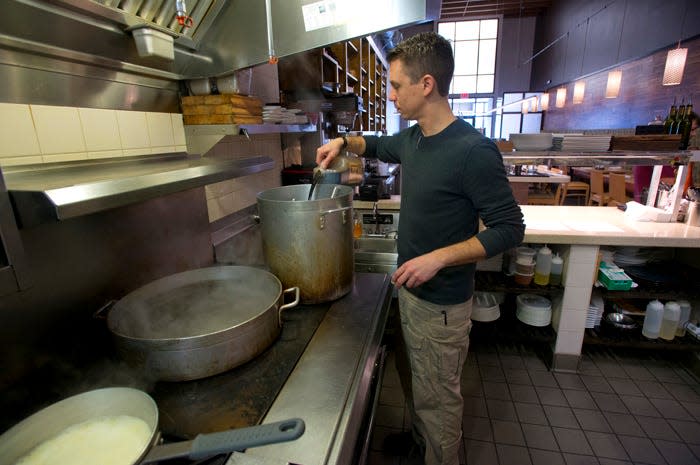 Alex McPhail, the head chef and co-owner of Restaurant Iron, prepares to stocks and sauces for the evenings service, is his new downtown Pensacola location. Iron recently received a Florida Trend Magazine Golden Spoon award.