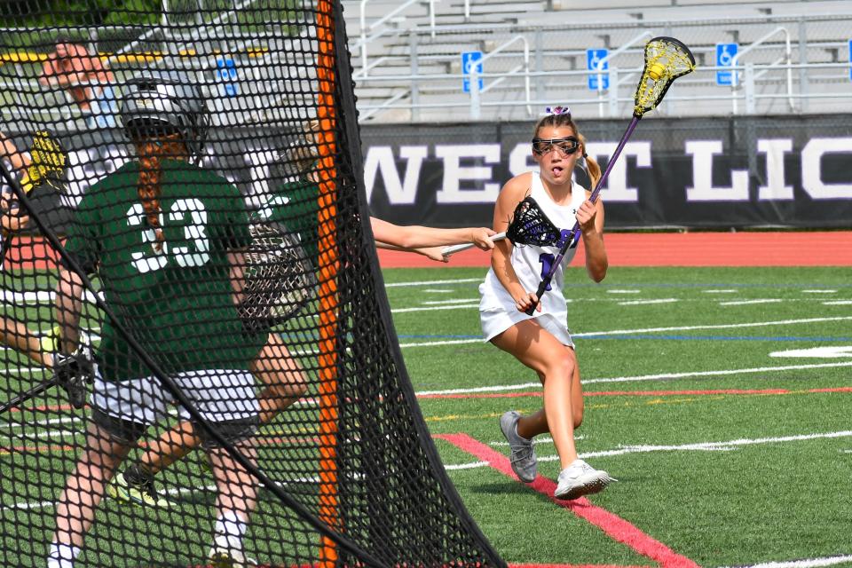 Cherry Hill West freshman Tatum Woods sizes up Mainland sophomore goalie Kylie Kurtz