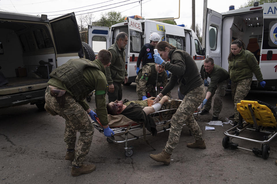 Ukrainian military medics move an injured Ukrainian serviceman to a hospital in Donetsk region, eastern Ukraine, Saturday, April 23, 2022. (AP Photo/Evgeniy Maloletka)