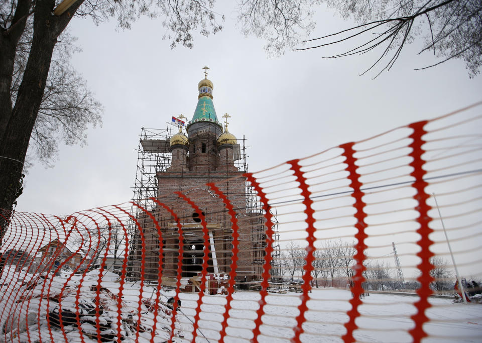 In this photo taken Friday, Jan. 11, 2019, a view of the new church under construction designed in the Russian style in the village Banstol in northwestern Serbia. Topped with Russia-style green and gold onion-shaped domes, the church in this tiny village in northwestern Serbia is still under construction but it has already been dubbed ''Putin's church.'' (AP Photo/Darko Vojinovic)